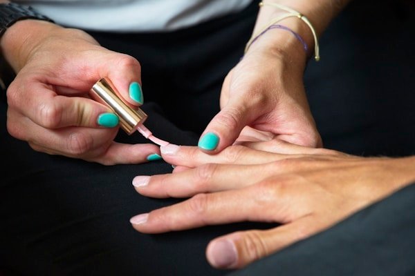 Painting nails with teal polish